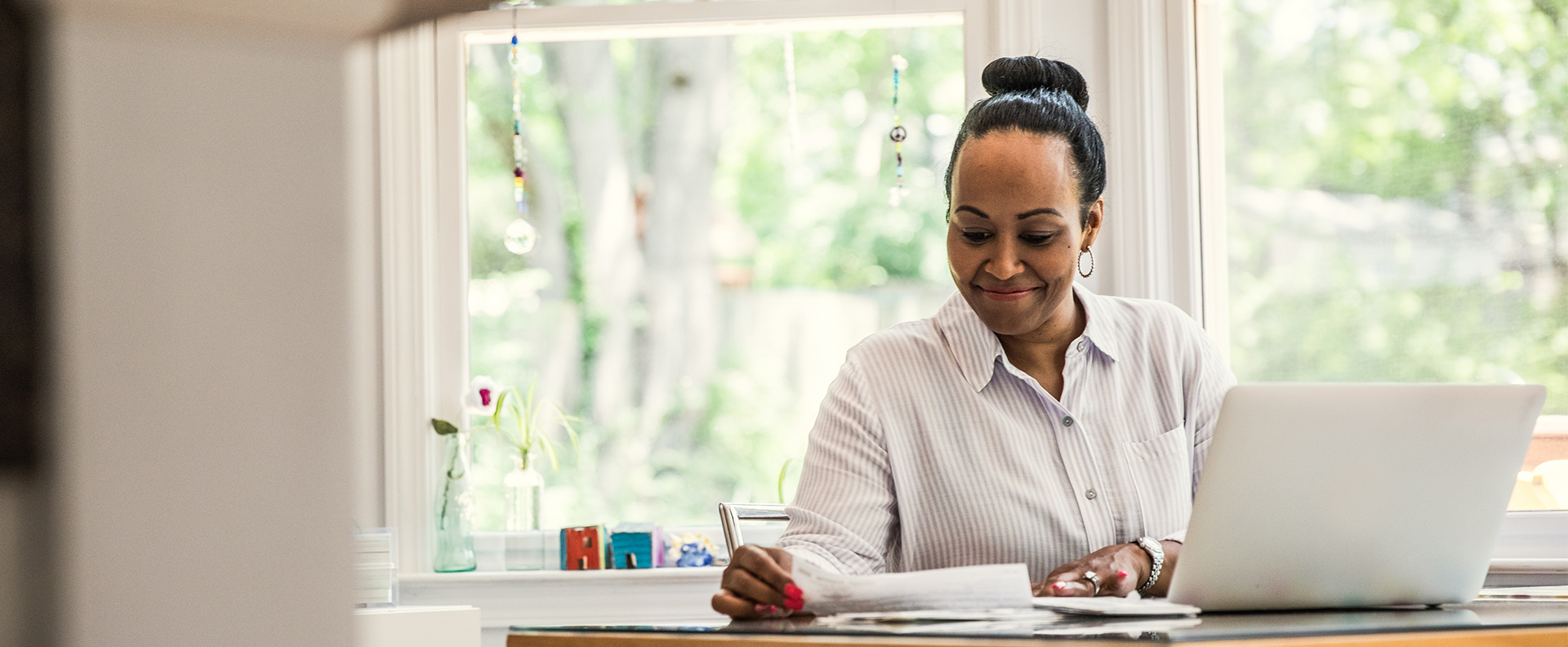 professional woman smiling while writing on paper