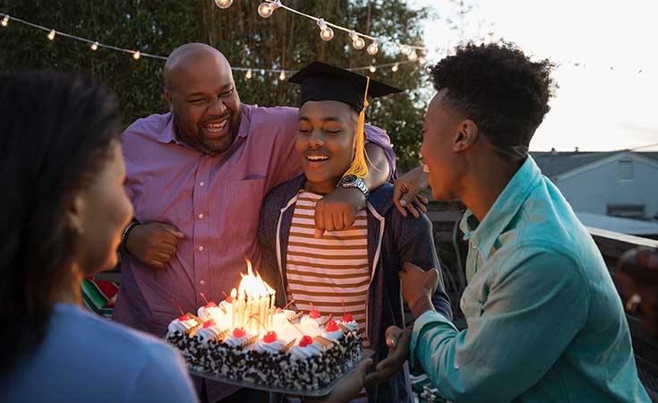 African American family celebrating teen son's birthday